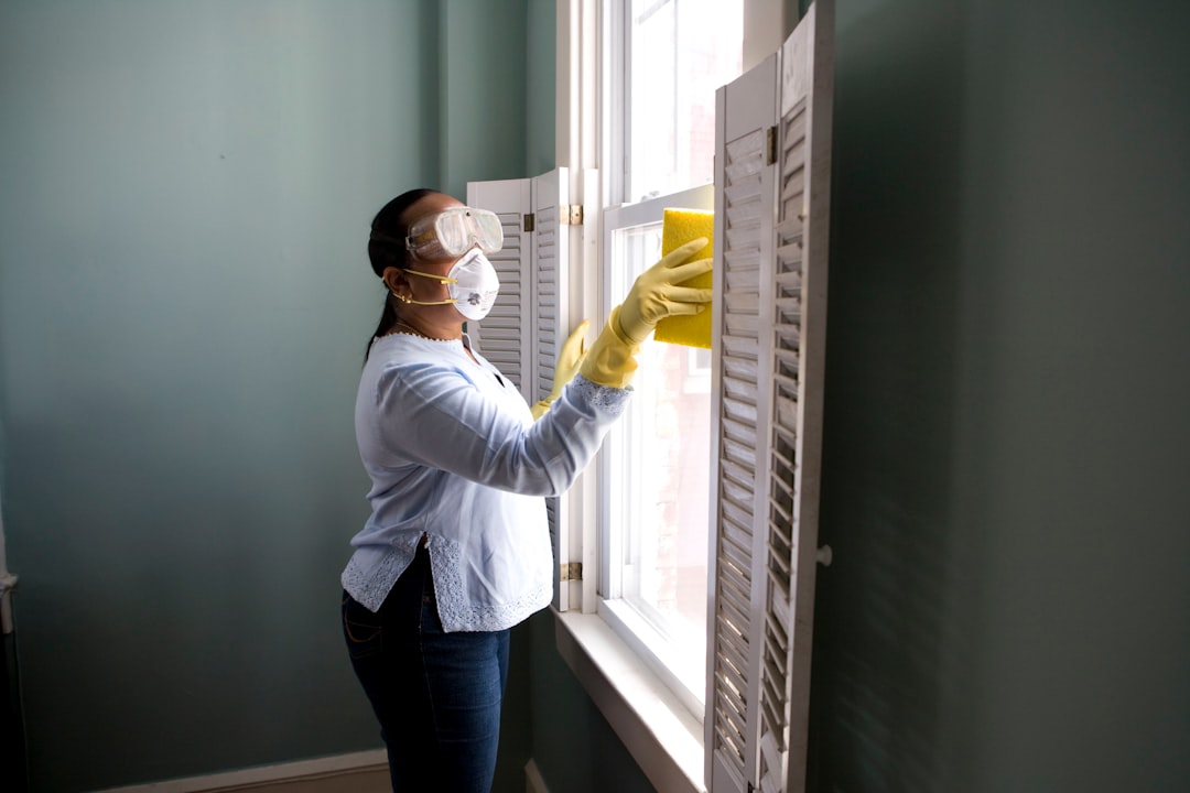 Services-01 When renovating a home, you should use a damp sponge or cloth to clean dust collected on a window sill, as the dust may contain asbestos or lead-based paint. Home maintenance is an ongoing process for any homeowner, and here we see an African- American woman who’d taken a damp sponge to her window’s frame, in order to remove accumulated dust particulates. Note how the homeowner had donned a pair of waterproof gloves, a facemask, and a pair of goggles, prior to beginning this task.